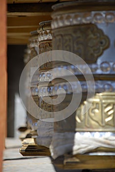 Prayer wheels aside Wanla Gompa, Ladakh photo