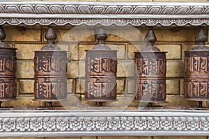 Prayer wheels with Chenrezig mantra, Nepal photo