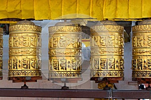 Prayer wheels is spun by devotees