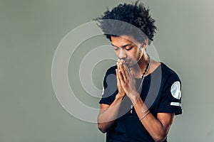 Praying african american man hoping for better. Asking God for good luck