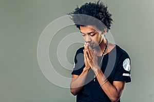 Praying african american man hoping for better. Asking God for good luck photo