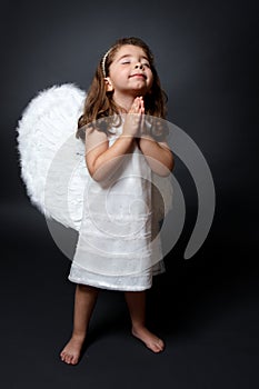 Praying angel with hands together in worship
