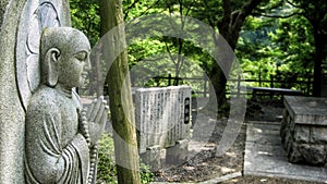 Praying Buddha statue in the Japanese garden in Tokyo (Japan)