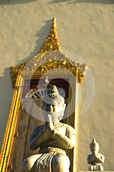 Praying buddha statue at a temple photo