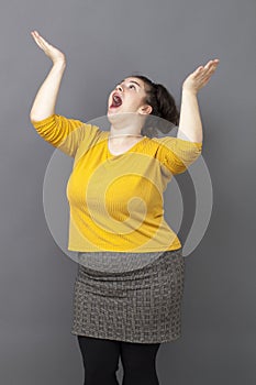 Praying concept for excited overweight 20s woman photo