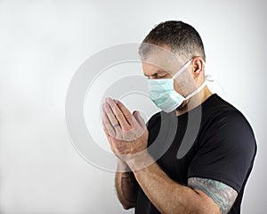 Praying with a face mask