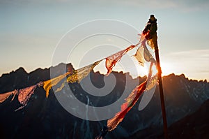 Praying flags in Rysy mountain at sunset