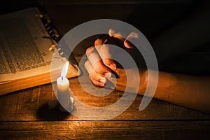 Praying hand of men with candle light