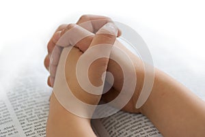 Praying hands on bible