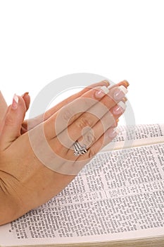 Praying hands on bible