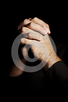 Praying, hands and black background for faith, hope and religion or asking for help with mental health or support in