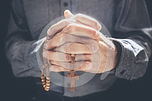 Praying hands with crucifix religious cross and rosary beads