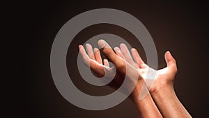 Praying hands with faith in religion and belief in God on dark background. Power of hope or love and devotion photo