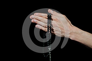 Praying hands holding rosary