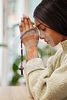 Praying, hands and Indian woman with a rosary in her home for worship, praise and gratitude to God. Jesus, pray and