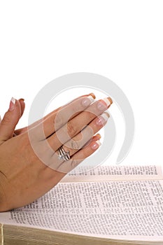 Praying hands on scripture