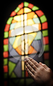 Praying Hands And Stained Glass Church Window