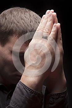 Praying man with eyes closed photo