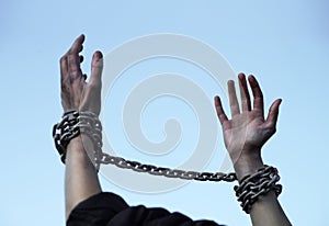 Praying man with shackled hands