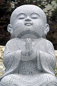Praying monk sculpture