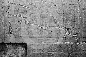 Praying notes in a gap of the wailing wall in black and white