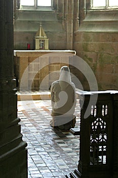 Praying nun in church