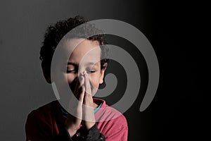 Praying to God with hands together with black background with people stock photo