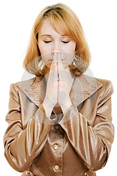 Praying woman in business suit with gold