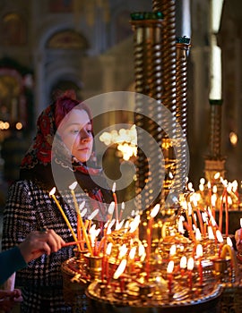 Praying young woman with candle