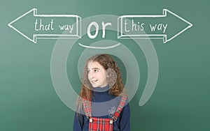 Pre-adolescent girl thinks about which way to choose, left or right