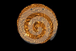 Pre-columbian ornamental gold disk photo