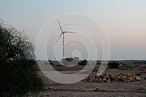 Pre dawn light in desert sky with Electrical power generating wind mills producing alterative eco friendly green energy.