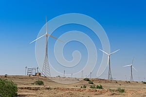 Pre dawn light in desert sky with Electrical power generating wind mills producing alterative eco friendly green energy for