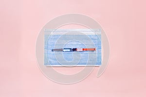 A pre-filled syringe with a ready-to-use medical solution rests on a small surgical mask.