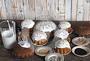 Pre holiday chores. Homemade Easter pastries with festive sprinkles for baking are displayed on a wooden background