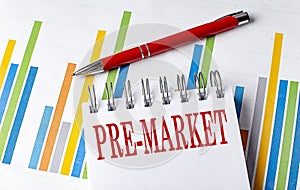 PRE MARKET text on a notebook with chart and pen business concept