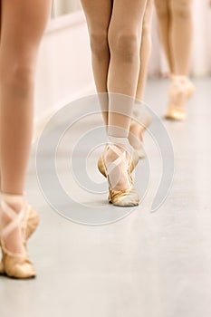 Pre-Pointe teenage girl ballet students practising barre work for ballet feet positions