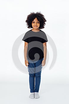 Pre-teen African American kid in casual style standing still