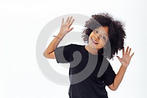 Pre-teen African American kid putting hands up being playful and happy