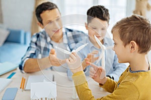 Pre-teen boy examining wind turbines in fathers office