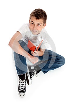 Pre teen boy sitting with a book