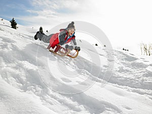 Pre-teen Boy On A Sled In The Snow photo