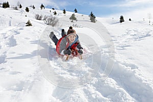 Pre-teen Boy On A Sled In The Snow