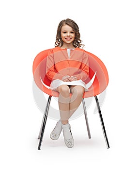 Pre-teen girl in casual clothes sitting on chair