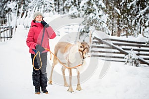 Pre-teen girl and reindeer in Lapland