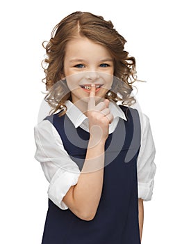 Pre-teen girl showing hush gesture