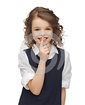 Pre-teen girl showing hush gesture