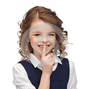 Pre-teen girl showing hush gesture