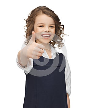 Pre-teen girl showing thumbs up