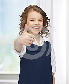 Pre-teen girl showing thumbs up